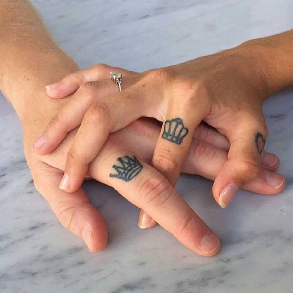 Matching couple tattoos on fingers